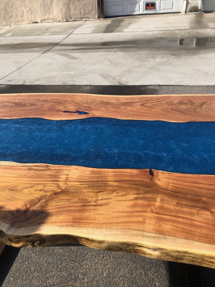 Black epoxy river table with burl wood inlay