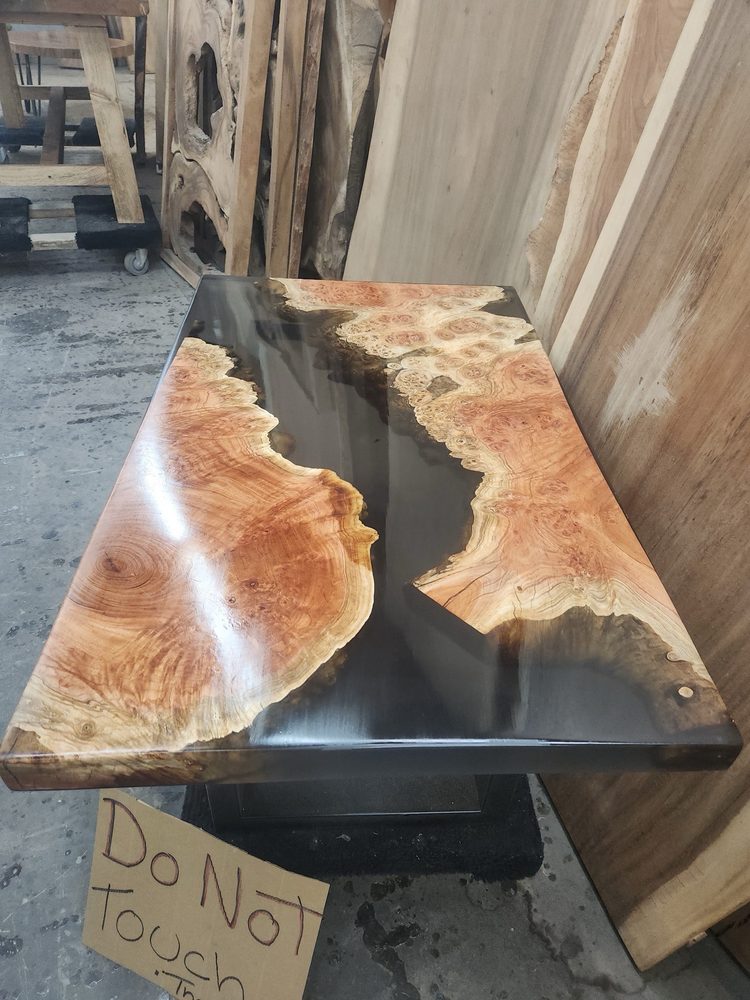 Live edge walnut slab table close up showing natural grain