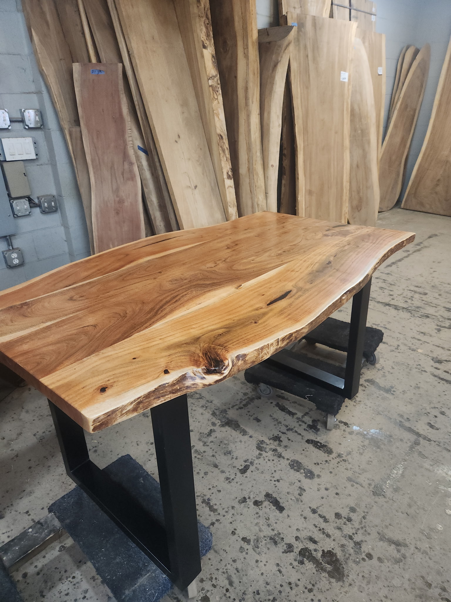 Live edge slab dining table on black U-shaped metal legs